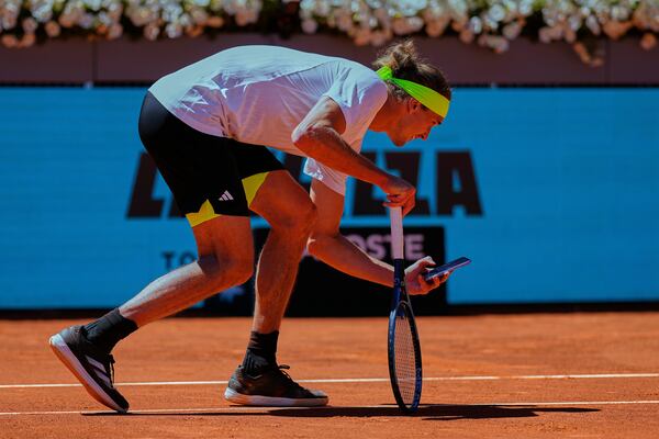 Alexander Zverev of Germany takes a picture with his phone during his Madrid Open round of 32 tennis match against Alejandro Davidovich Fokina of Spain, in Madrid, Spain, Sunday, April 27, 2025. (AP Photo/Manu Fernandez)