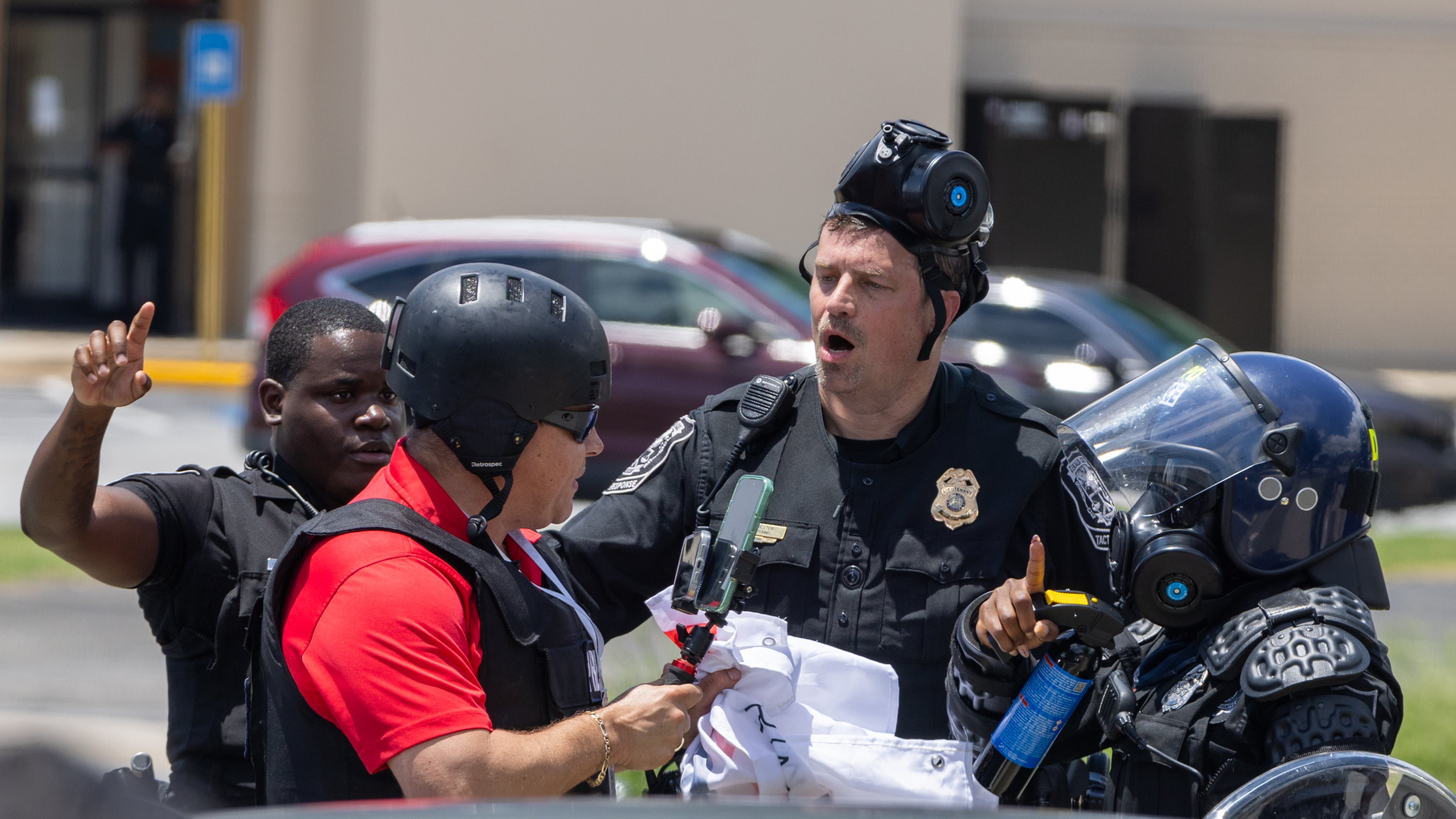 Police tell Spanish-language reporter Mario Guevara to move back during a protest on ICE raids and deportation arrests on Chamblee Tucker Road in Atlanta on Saturday, June 14, 2025. (Arvin Temkar / AJC)