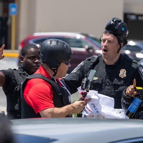 Police tell Spanish-language reporter Mario Guevara to move back during a protest on ICE raids and deportation arrests on Chamblee Tucker Road in Atlanta on Saturday, June 14, 2025. (Arvin Temkar / AJC)