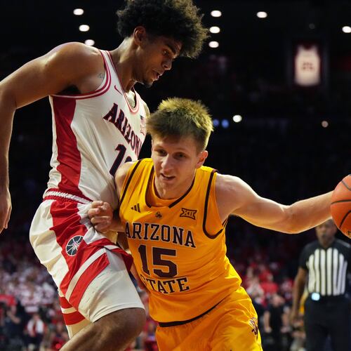 Arizona State guard Noah Meeusen (15) drives on Arizona forward Koa Peat during the first half of an NCAA college basketball game, Wednesday, Jan. 14, 2026, in Tucson, Ariz. (AP Photo/Rick Scuteri)