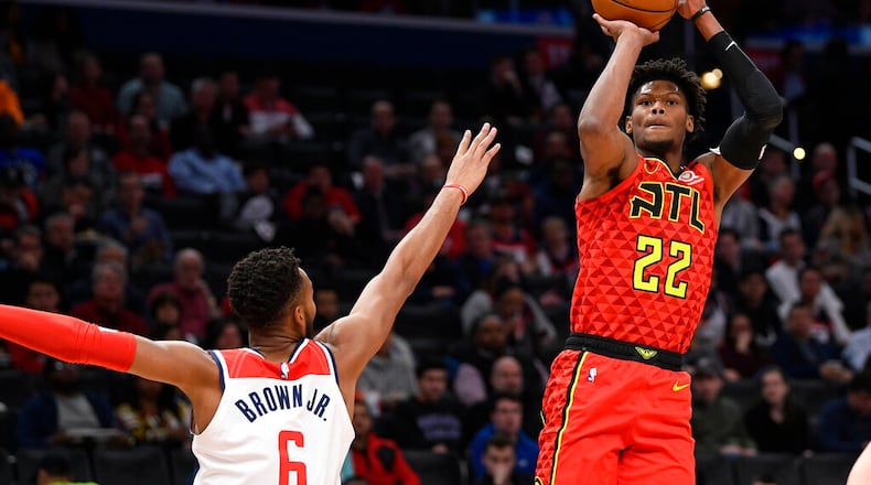 Atlanta Hawks guard Cam Reddish (22) shoots next to Washington Wizards forward Troy Brown Jr. (6) during the first half of an NBA basketball game, Friday, March 6, 2020, in Washington. (AP Photo/Nick Wass)