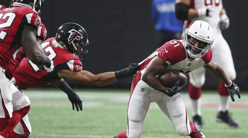 Arizona Cardinals running back David Johnson (31) moves as Atlanta Falcons outside linebacker Duke Riley (42) makes the tackle during the first half of an NFL football game, Saturday, Aug. 26, 2017, in Atlanta. (AP Photo/John Bazemore)