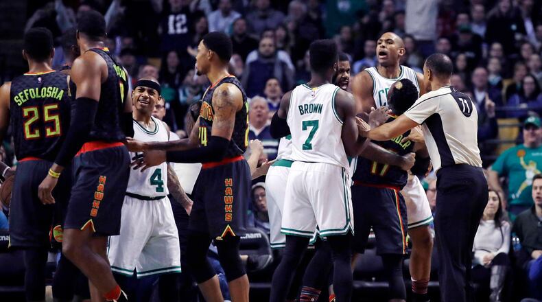 Boston Celtics center Al Horford, right, is held back after being fouled by Atlanta Hawks center Dwight Howard, second from left, during the second half of an NBA basketball game in Boston, Monday, Feb. 27, 2017. The Hawks defeated the Celtics 114-98. (AP Photo/Charles Krupa)
