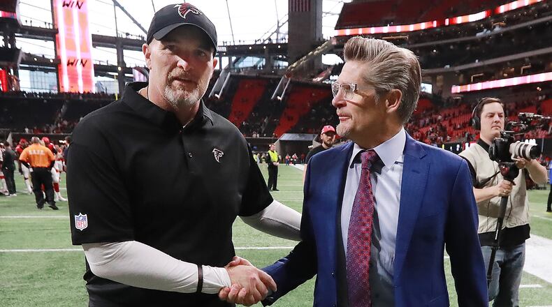 Falcons general manager Thomas Dimitroff  (right) congratulates head coach Dan Quinn on a 40-14 victory over the Cardinals in mid-December.