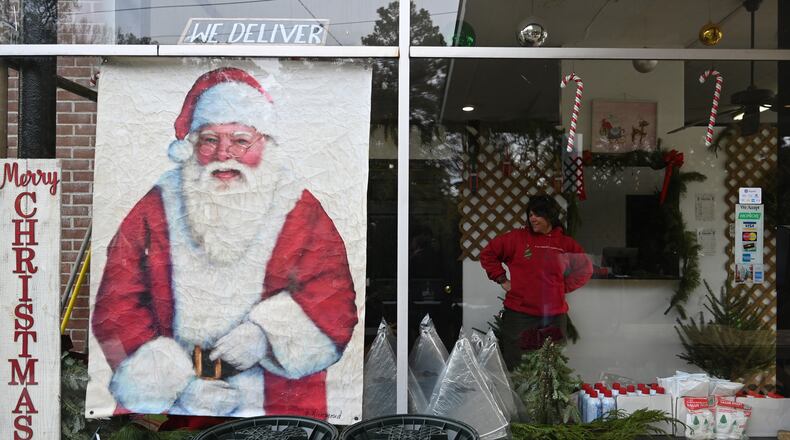 Michelle Stell smiles as she chats with other staff members Dec. 4 at Tradition Trees’ Chamblee lot in Atlanta. (Hyosub Shin/The Atlanta Journal-Constitution)