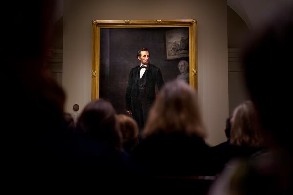 FILE - People gather for a ribbon cutting ceremony at the Smithsonian's National Portrait Gallery to announce the installation of a life-size painting of President Abraham Lincoln by artist W.F.K. Travers, Feb. 10, 2023, in Washington. (AP Photo/Carolyn Kaster, File)