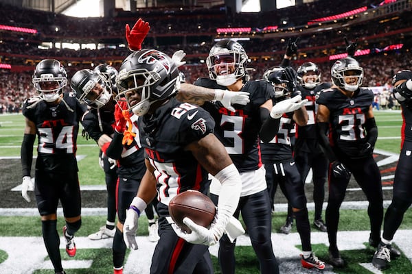 Falcons players celebrate with cornerback Dee Alford after his second-half interception against New Orleans.