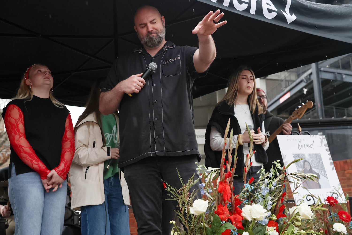 Derek Anglin, lead pastor of NewGrace Church in Commerce, Ga., leads a worship service at UGA’s Tate Plaza on Saturday, Feb. 21, 2026, at a memorial for Augusta University nursing student Laken Riley. Riley was attacked on Feb. 22, 2024 while running in Oconee Forest Park on the UGA campus and killed. Anglin’s sermon “Run for Your Life” inspired the memorial event’s title. (C.J. Bartunek for the AJC)
