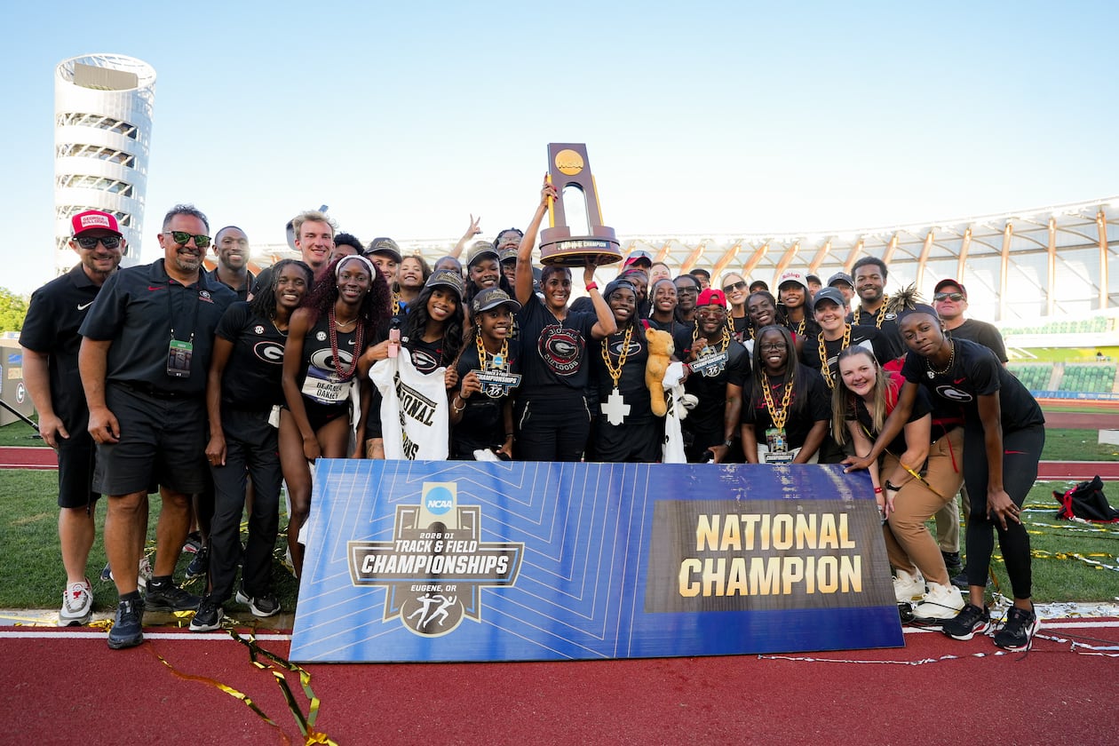 Caryl Smith Gilbert hoists the trophy as Georgia celebrates its second NCAA outdoor track & field championship. (DawgNation)