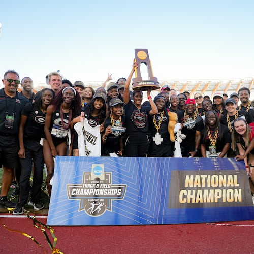 Caryll Smith-Gilbert hoists the trophy as Georgia celebrates its second NCAA outdoor track & field championship. (DawgNation)