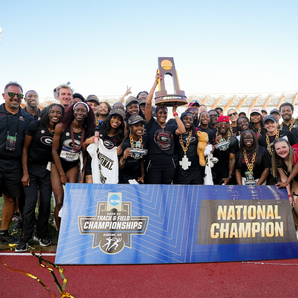 Caryll Smith-Gilbert hoists the trophy as Georgia celebrates its second NCAA outdoor track & field championship. (DawgNation)