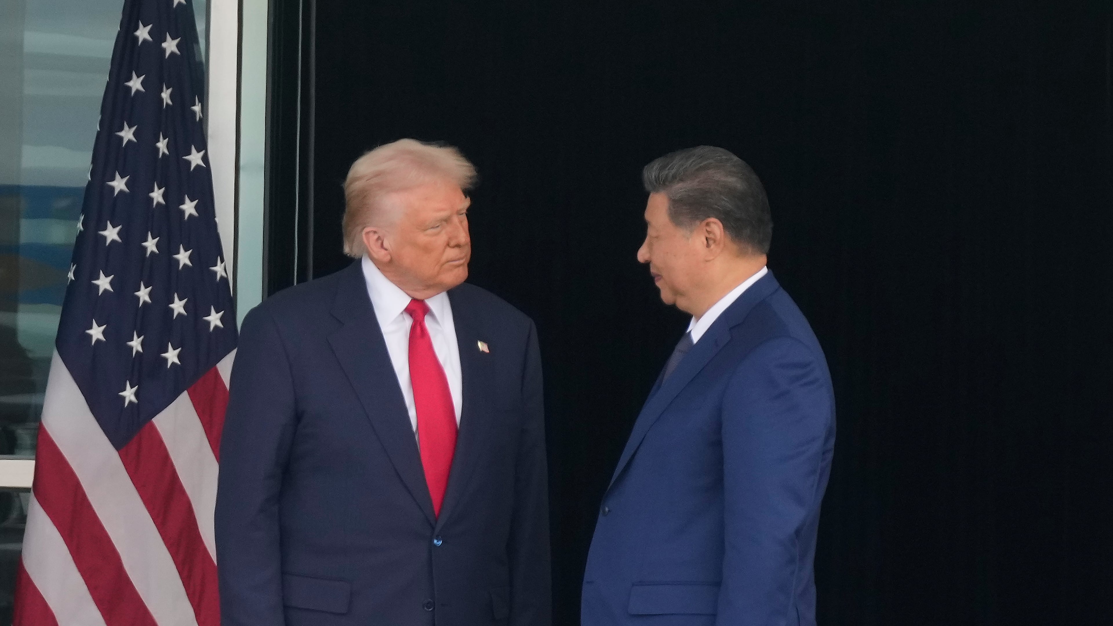 President Donald Trump, left, and Chinese President Xi Jinping, look at each other after their summit meeting at Gimhae International Airport Jinping in Busan, South Korea, Thursday, Oct. 30, 2025. (AP Photo/Mark Schiefelbein)