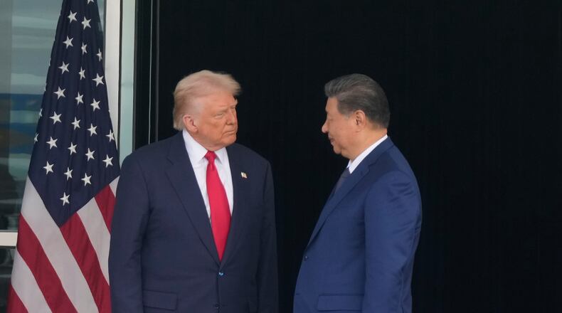 President Donald Trump, left, and Chinese President Xi Jinping, look at each other after their summit meeting at Gimhae International Airport Jinping in Busan, South Korea, Thursday, Oct. 30, 2025. (AP Photo/Mark Schiefelbein)