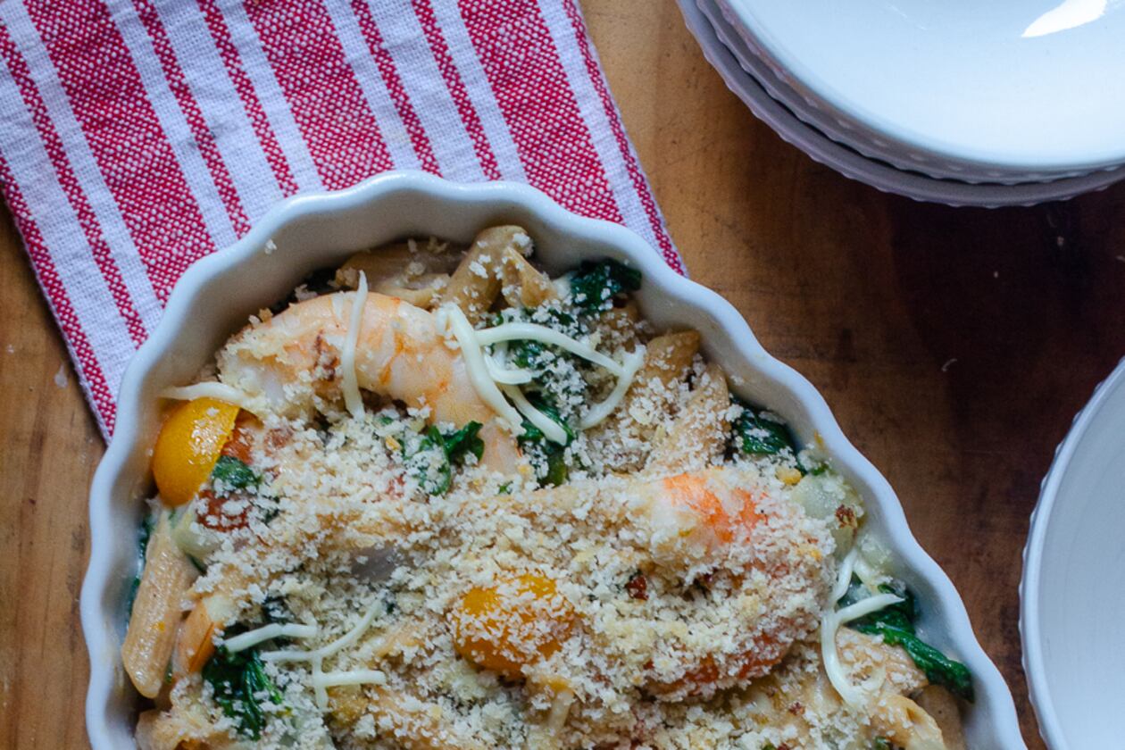 Shrimp, spinach and other vegetables are paired with whole wheat pasta for a well-rounded mac and cheese meal. (Virginia Willis for The Atlanta Journal-Constitution)