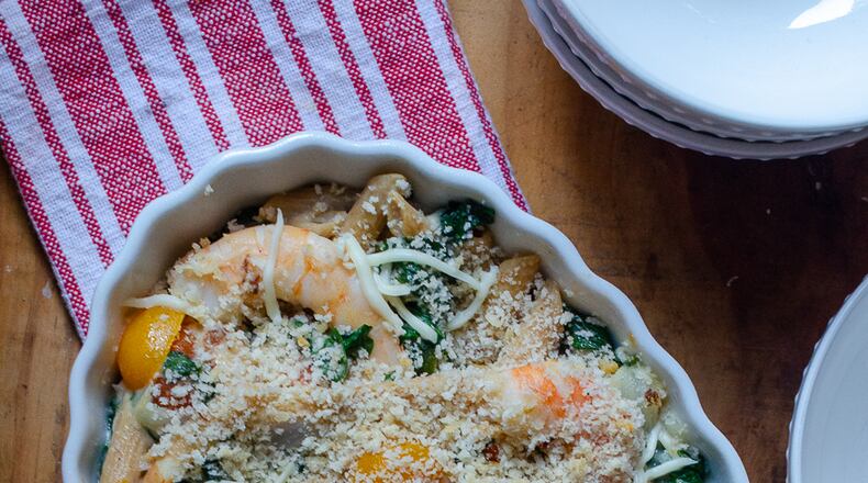 Shrimp, spinach and other vegetables are paired with whole wheat pasta for a well-rounded mac and cheese meal. (Virginia Willis for The Atlanta Journal-Constitution)