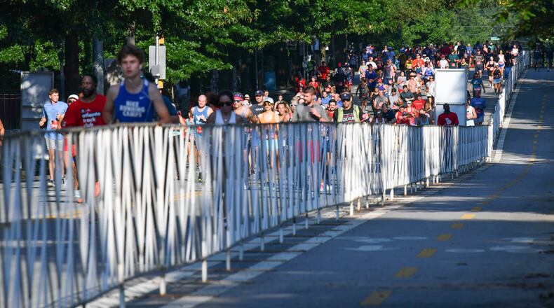 7/4/21 - Atlanta,  GA - Runners near the finish line as the AJC Peachtree Road Race returned in-person for the second day Sunday for the holiday tradition.  Hyosub Shin / Hyosub.shin@ajc.com