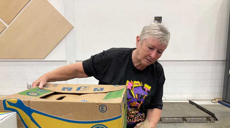Carolyn Shipman serves at the Atlanta Community Food Bank Feb. 25 with the Dragon Con Superheroes, a community outreach program she's been involved with since 2014. Courtesy of Greg Euston