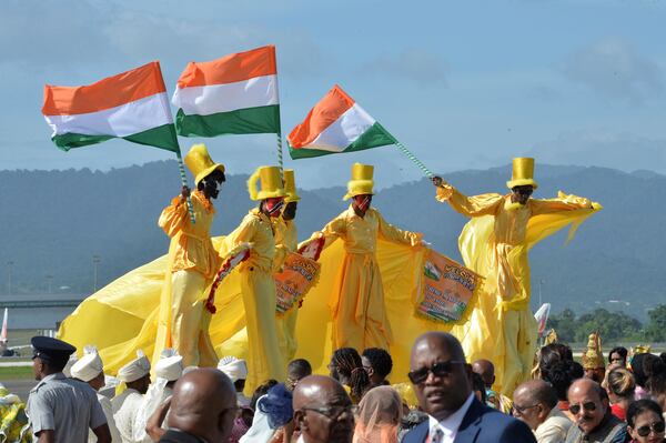 Moko Jumbies wave Indian flags during Indian Prime Minister Narendra Modi's arrival at Piarco International Airport in Piarco, Trinidad and Tobago, Thursday, July 3, 2025. (AP Photo/Jermaine Cruickshank)