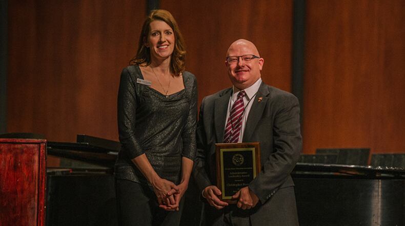 Best in the state goes to Christopher Ferrell, Cobb County School District Supervisor of Instrumental Music, as the Administrator of the Year by the Georgia Music Educators Association. Presenting him with the award is GMEA President Evelyn Champion. Among accomplishments this year will be Hillgrove High’s band marching in the 75th Anniversary of D-Day Parade in Normandy, France in June. (Courtesy of Cobb County School District)