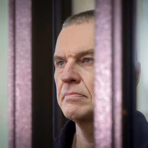 FILE - Journalist Andrzej Poczobut stands in a defendants' cage in court in Grodno, Belarus, on Jan. 16, 2023. (Leonid Shcheglov/Pool via AP, File)