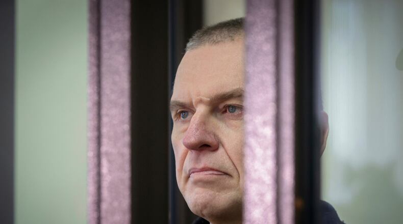 FILE - Journalist Andrzej Poczobut stands in a defendants' cage in court in Grodno, Belarus, on Jan. 16, 2023. (Leonid Shcheglov/Pool via AP, File)