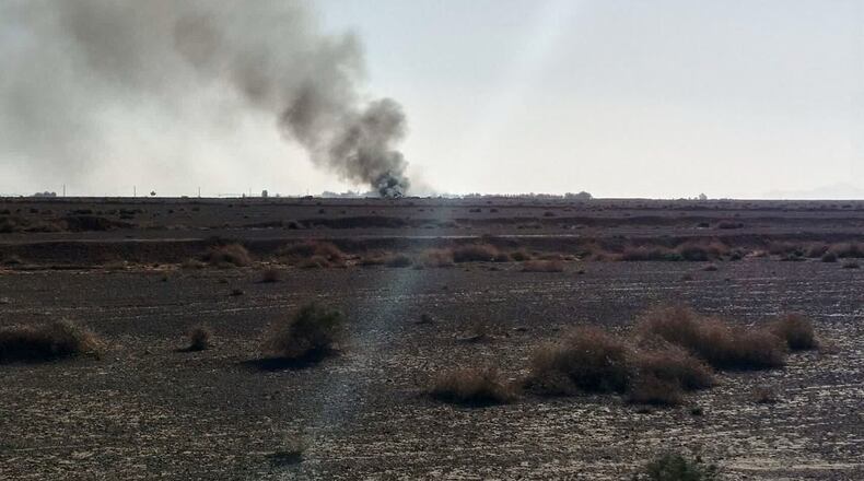 In this image provided by Sepahnews, the Iranian Revolutionary Guard's official website, black smoke rises into the air at what Iran's state TV claimed was the site where an American transport plane and two helicopters involved in a rescue operation were shot down, in Isfahan province, Iran, April, 2026. (Sepahnews via AP)