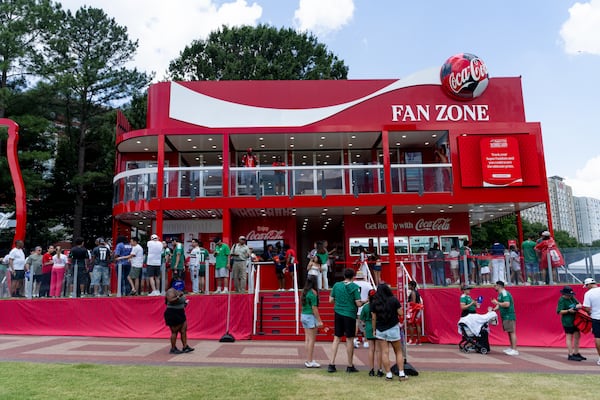 People line up to enter the Coca-Cola Fan Zone booth on opening day of the FIFA Fan Festival at Centennial Olympic Park on Thursday, June 11, 2026. (Ben Hendren for the AJC)