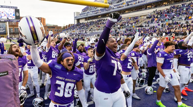 James Madison players celebrate defeating Washington State in an NCAA college football game, Saturday, Nov. 22, 2025, in Harrisonburg, Va. (AP Photo/Ryan M. Kelly)
