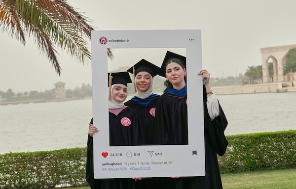 The American University of Iraq - Baghdad graduates take photos during the first graduation for the school in Baghdad, Iraq, Saturday, May 24, 2025. (AP Photo/Hadi Mizban)