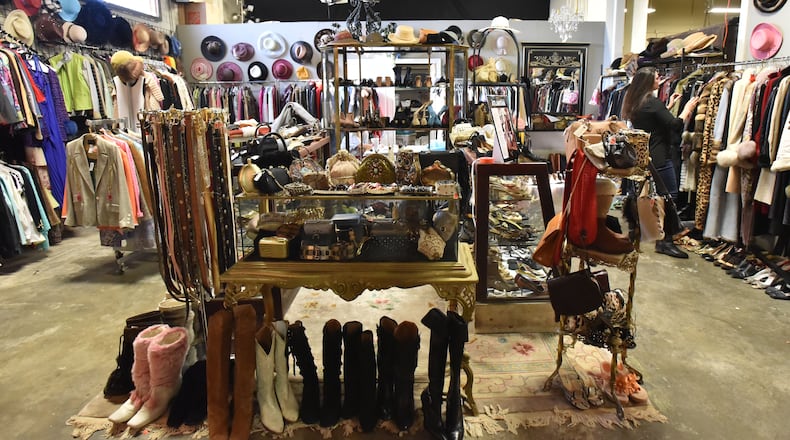 December 2, 2016 Atlanta - Christy Ogletree Ahlers, owner of Peachtree Battle Estate Sales and Liquidations, prepares for the estate sale of Diane McIver's wardrobe next week as she is surrounded by more than 2,000 of Diane McIver's clothing and jewelry items in a warehouse showroom at Peachtree Battle Estate Sales and Liquidations on Friday, December 2, 2016. More than 2,000 of her articles of clothing, jewelry, hats and shoes are on display. Tex McIver has enlisted an estate liquidation company to sell more than 2,000 of his deceased wife's clothing and jewelry items. HYOSUB SHIN / HSHIN@AJC.COM