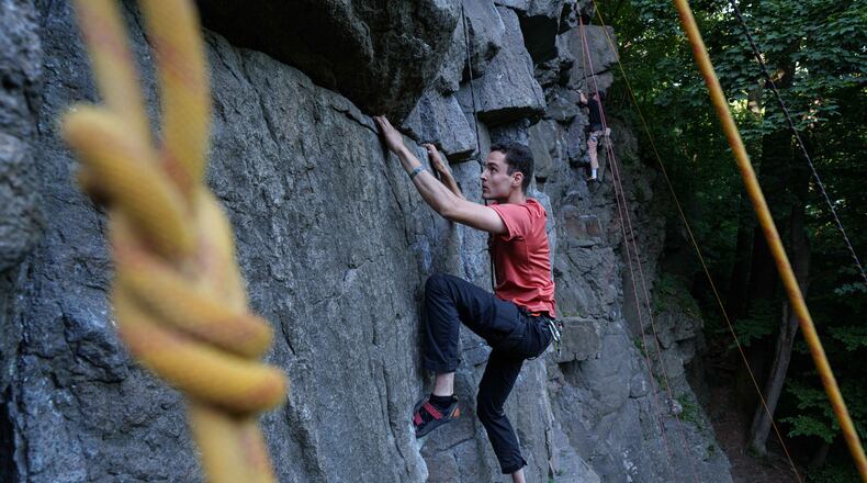 A man climbs on a cliff during the Stoned Climbers festival near Denyshi, Zhytomyr region, Ukraine, Saturday, June 27, 2026. (AP Photo/Evgeniy Maloletka)