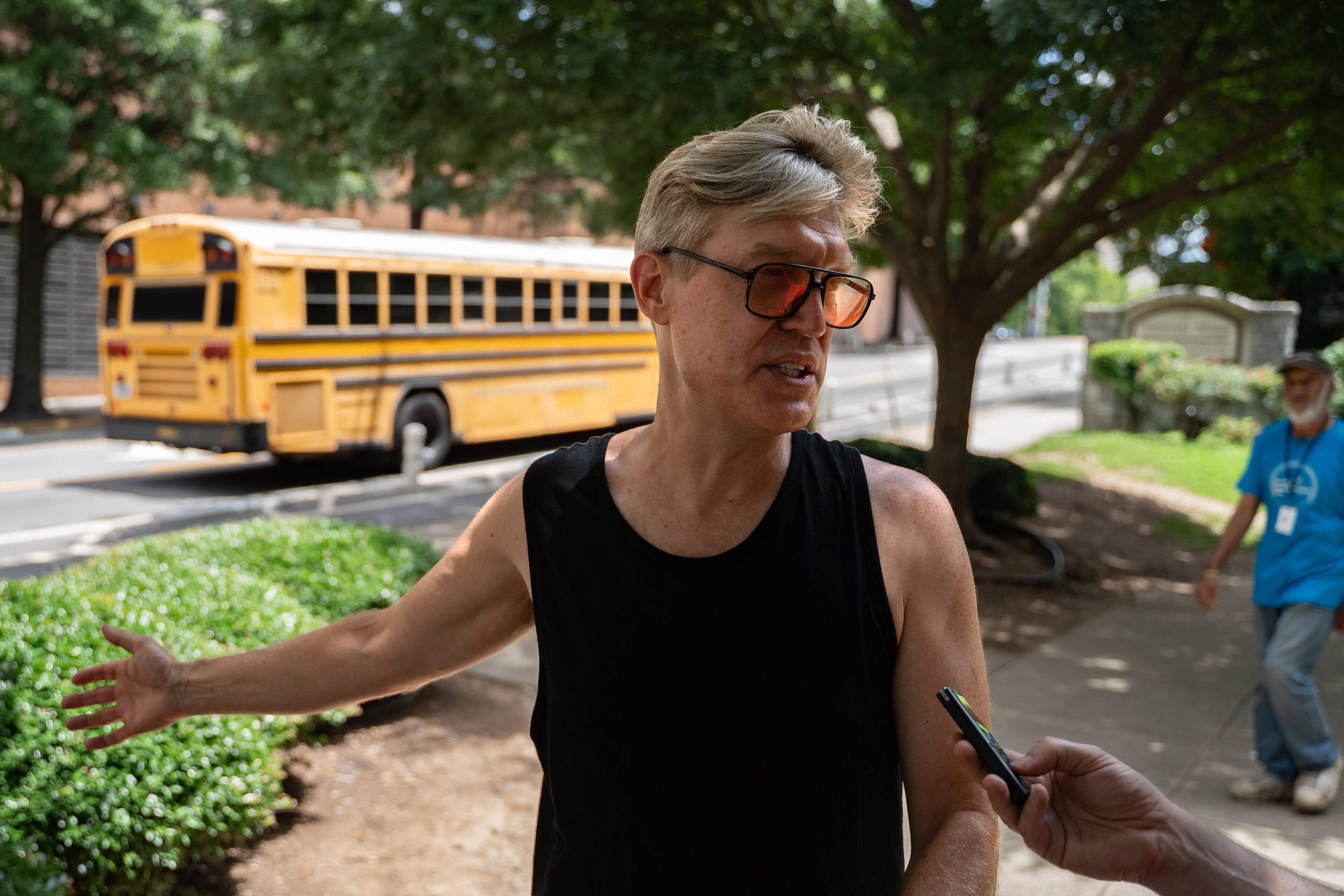 Tim Franzen with the Cornelius Taylor Coalition for Justice speaks to the AJC after over 20 unhoused individuals are relocated to The Welcome House from Old Wheat Street, Thursday, July 10, 2025 (Ben Hendren for the AJC)