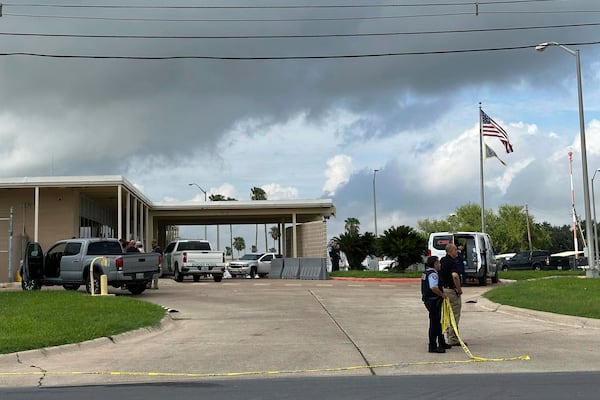 Officials work the scene of a shooting at a Border Patrol facility in McAllen, Texas, Monday, July 7, 2025. (AP Photo/Valerie Gonzalez)