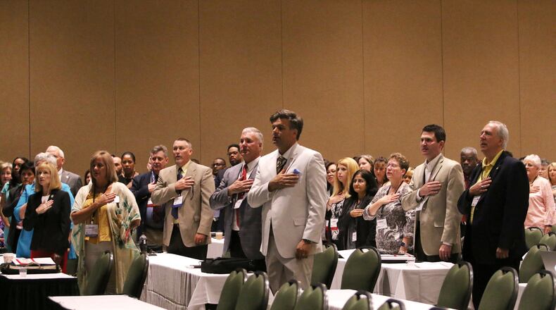 Georgia tax officials say the pledge of allegiance during the Georgia Association of Tax Officials Conference on May 6, 2019, at the Classic Center in Athens. CHRISTINA R. MATACOTTA / CHRISTINA.MATACOTTA@AJC.COM
