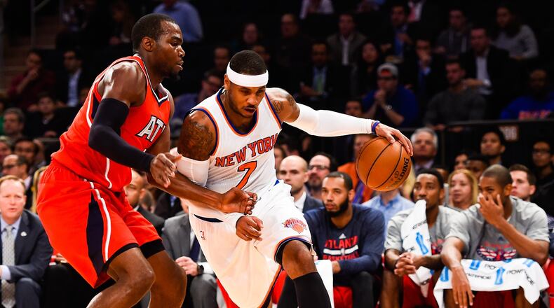 The Knicks’ Carmelo Anthony (7) attempts to drive past the Hawks’ Paul Millsap (4) in a game last week. (Photo by Alex Goodlett/Getty Images)