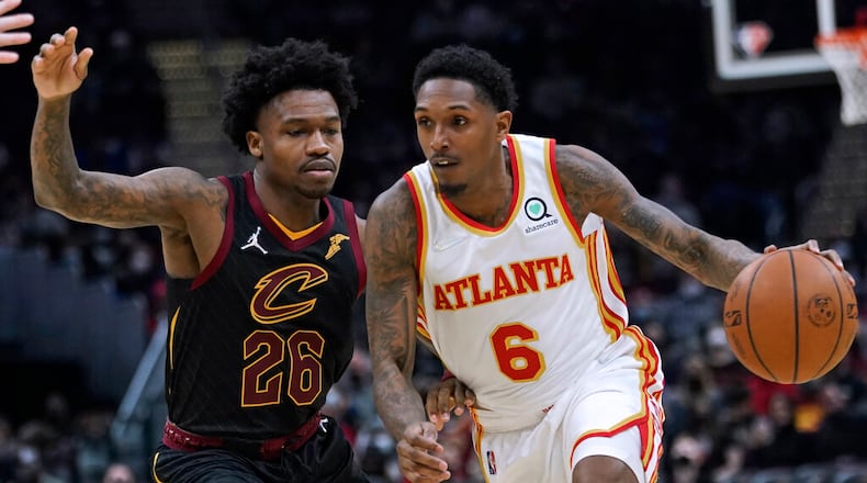 Atlanta Hawks' Lou Williams (6) drives against Cleveland Cavaliers' Brandon Goodwin (26) during the second half of an NBA basketball game Friday, Dec. 31, 2021, in Cleveland. Atlanta won 121-118. (AP Photo/Tony Dejak)