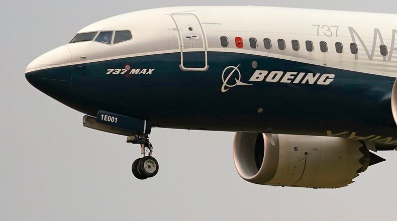 FILE - A Boeing 737 Max jet prepares to land at Boeing Field following a test flight in Seattle, Sept. 30, 2020. (AP Photo/Elaine Thompson, File)