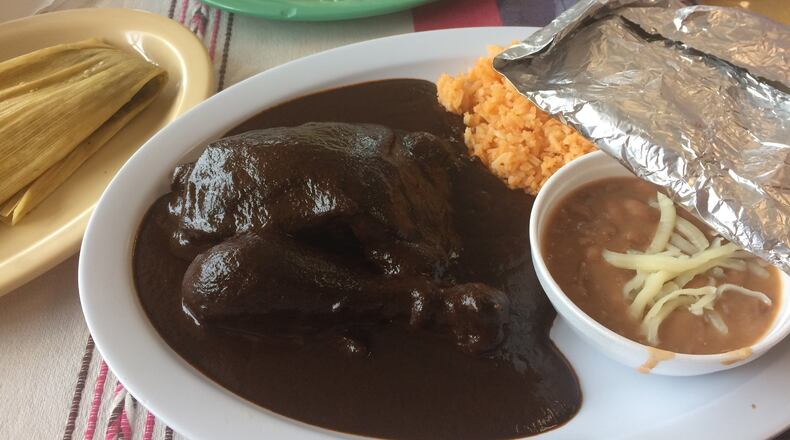 The chicken mole is a wonderful way to sample the traditional Oaxacan fare at Taqueria La Oaxaqueña in Jonesboro. Above left: a tamale with pork and green salsa and a sope with lengua. CONTRIBUTED BY WENDELL BROCK