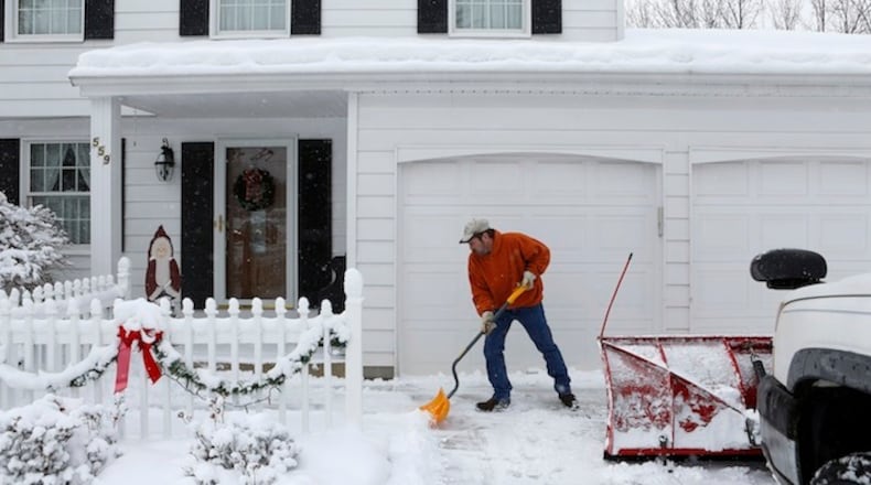 After shoveling a client's driveway, Chris Wade shovels the walkway. Wade worked at Delphi Automotive Systems for 13 and a half years before taking a buyout in 2006 as part of the company's ongoing shift of production out of the U.S. (Katie Falkenberg/Los Angeles Times/TNS)
