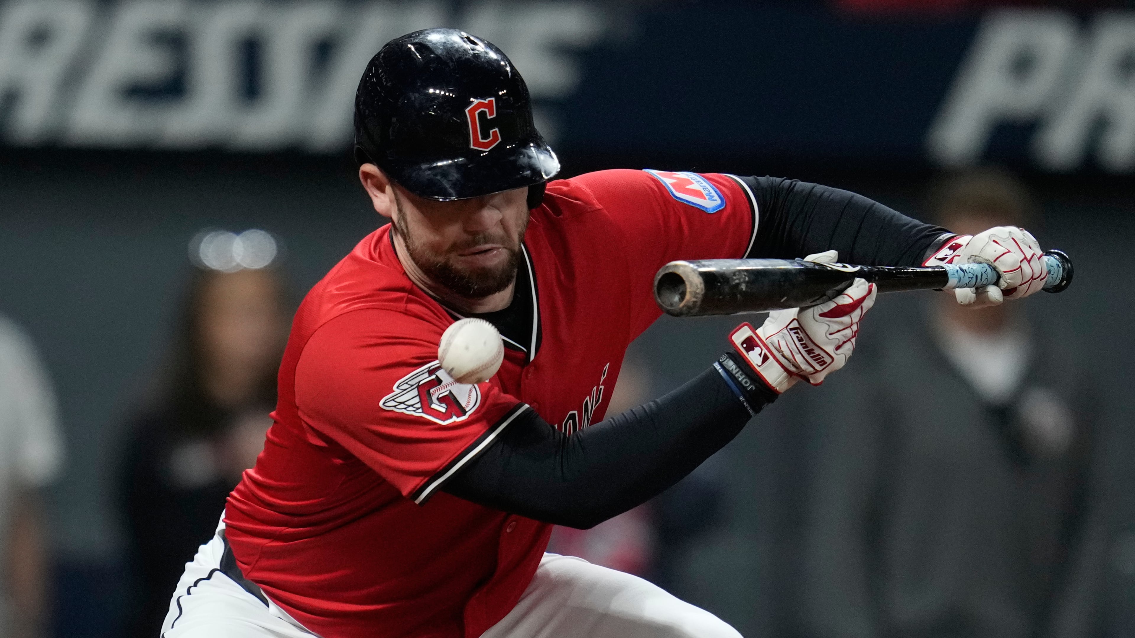 Cleveland Guardians' David Fry is hit in the face with his own bunt in the sixth inning of a baseball game against the Detroit Tigers in Cleveland, Tuesday, Sept. 23, 2025. (AP Photo/Sue Ogrocki)