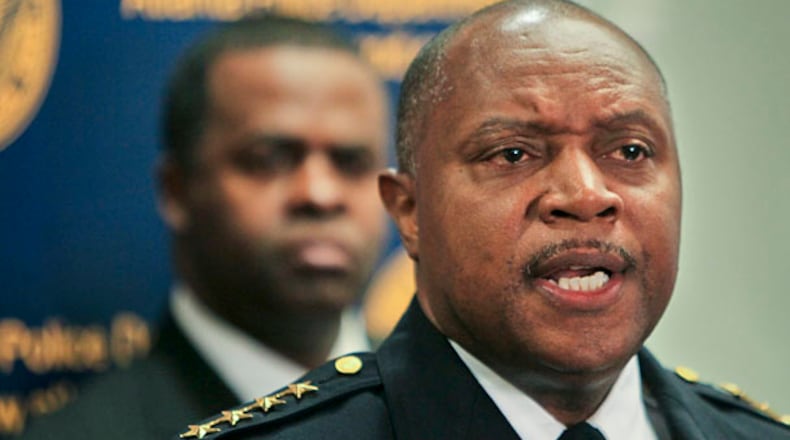 Mayor Kasim Reed listens to Atlanta Police Department Chief George Turner announce on Monday, Feb. 7, 2011, that he is disbanding the controversial Red Dog narcotics unit.