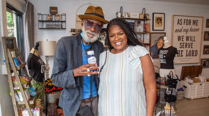 Customer Hershel Hamilton (left) stands with LaTonya Gates in the PAWkids food pantry and store in Grove Park on the Westside of Atlanta. PHIL SKINNER FOR THE ATLANTA JOURNAL-CONSTITUTION.