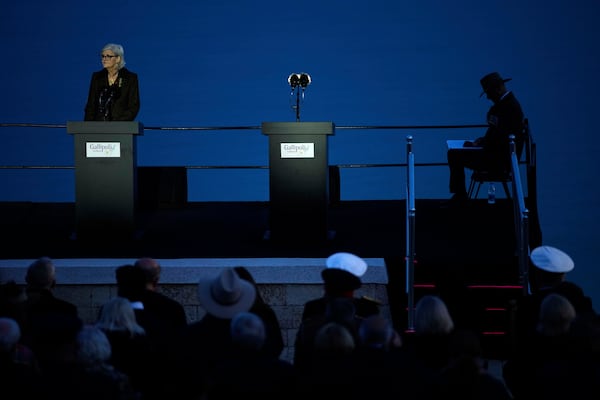 Governor-general of Australia, Sam Mostyn, left, delivers a speech during the "Spirit of Place" ceremony and dawn memorial service at the Anzac Cove beach, the site of the April 25, 1915, World War I landing of the ANZAC (Australian and New Zealand Army Corps) on the Gallipoli peninsula, near Canakkale, Turkey, early Friday, April 25, 2025. (AP Photo/Emrah Gurel)