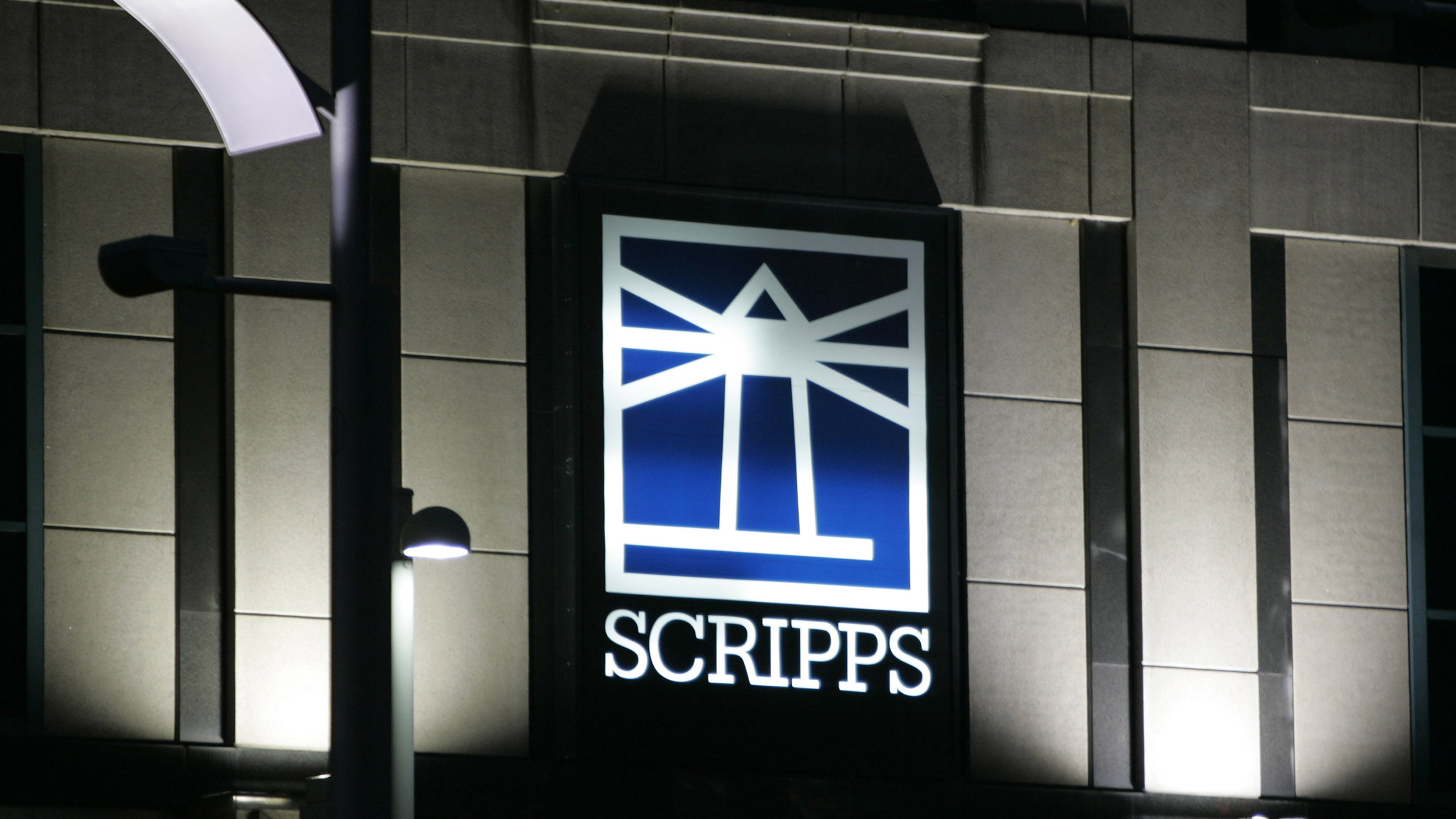 FILE - Floodlights light up the E.W. Scripps logo on the company's headquarters in Cincinnati, Jan. 31, 2006. (AP Photo/Al Behrman, File)