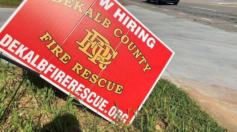 A "now hiring" sign sits outside a DeKalb County Fire Rescue station in Dunwoody on Thursday, April 21, 2022. J. SCOTT TRUBEY