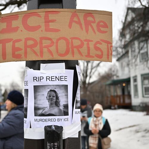 People gather around a makeshift memorial honoring the victim of a fatal shooting involving federal law enforcement agents, near the site of the shooting, Thursday, Jan. 8, 2026, in Minneapolis. (AP Photo/Tom Baker)