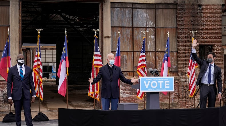 President Joe Biden -- shown flanked by Democratic U.S. Sens. Raphael Warnock, left, and Jon Ossoff during a campaign visit to the state in January -- will return to Georgia on March 19 to celebrate passage of the $1.9 trillion stimulus relief package. (Drew Angerer/Getty Images/TNS)