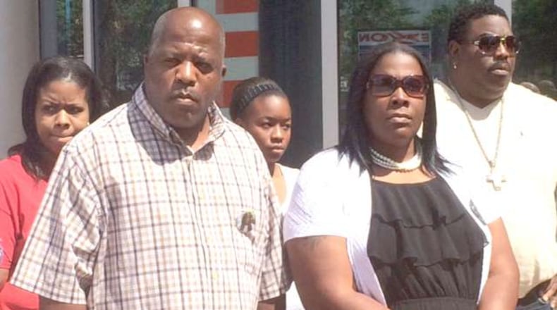 Kenneth and Jackie Johnson, front, react to the U.S. Department of Justice’s decision not to bring criminal charges in their son Kendrick’s death. Christian Boone / cboone@ajc.com