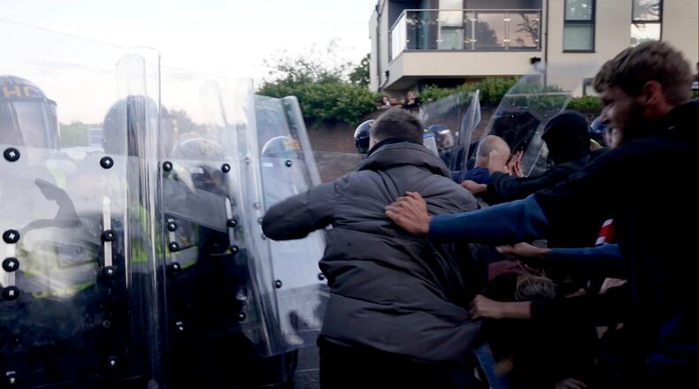 In this image taken from PA Video, police and protestors clash during a protest following the death of Henry Nowak, a 18-year-old student stabbed to death with a Sikh kirpan ceremonial by Vickrum Digwa, in Southampton, England, Tuesday June 2, 2026. (Jamie Lashmar/PA via AP)
