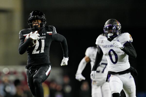 Cincinnati wide receiver Tyler Scott (21) runs for a touchdown during an NCAA college football game against East Carolina, Friday, Nov. 11, 2022, in Cincinnati. (AP Photo/Jeff Dean)